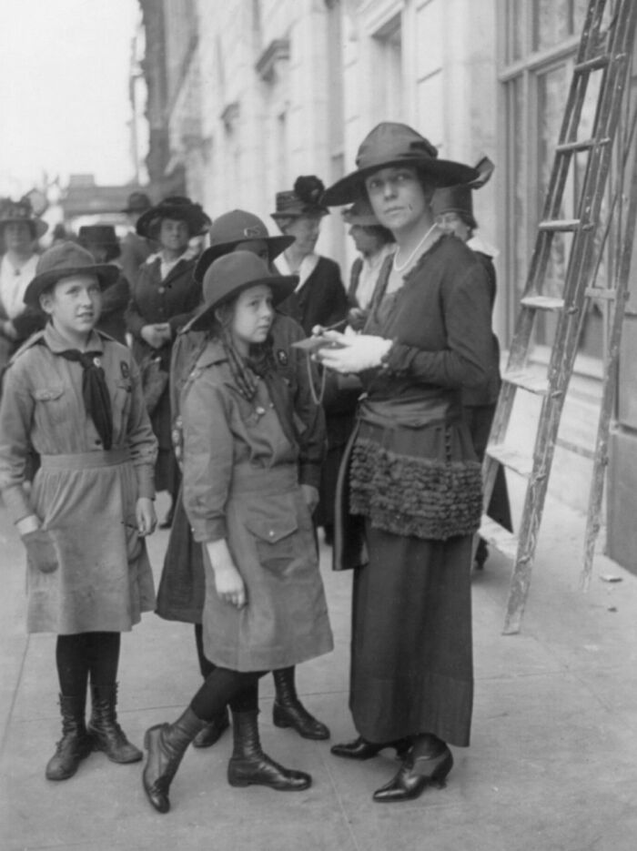 Women and girls gathered outdoors during WWI, showcasing daily life beyond the WWI trenches in a historical black and white photo.