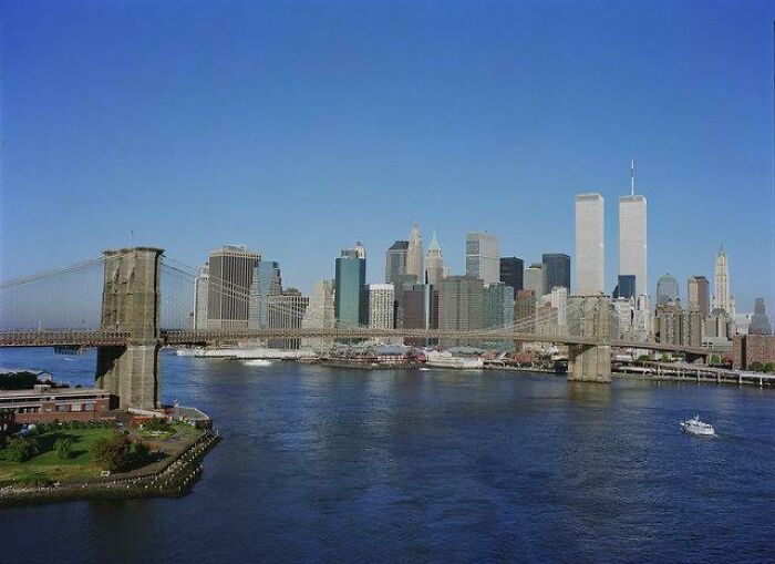 Clear photo of the New York City skyline with Brooklyn Bridge, featuring the Twin Towers before disaster struck.