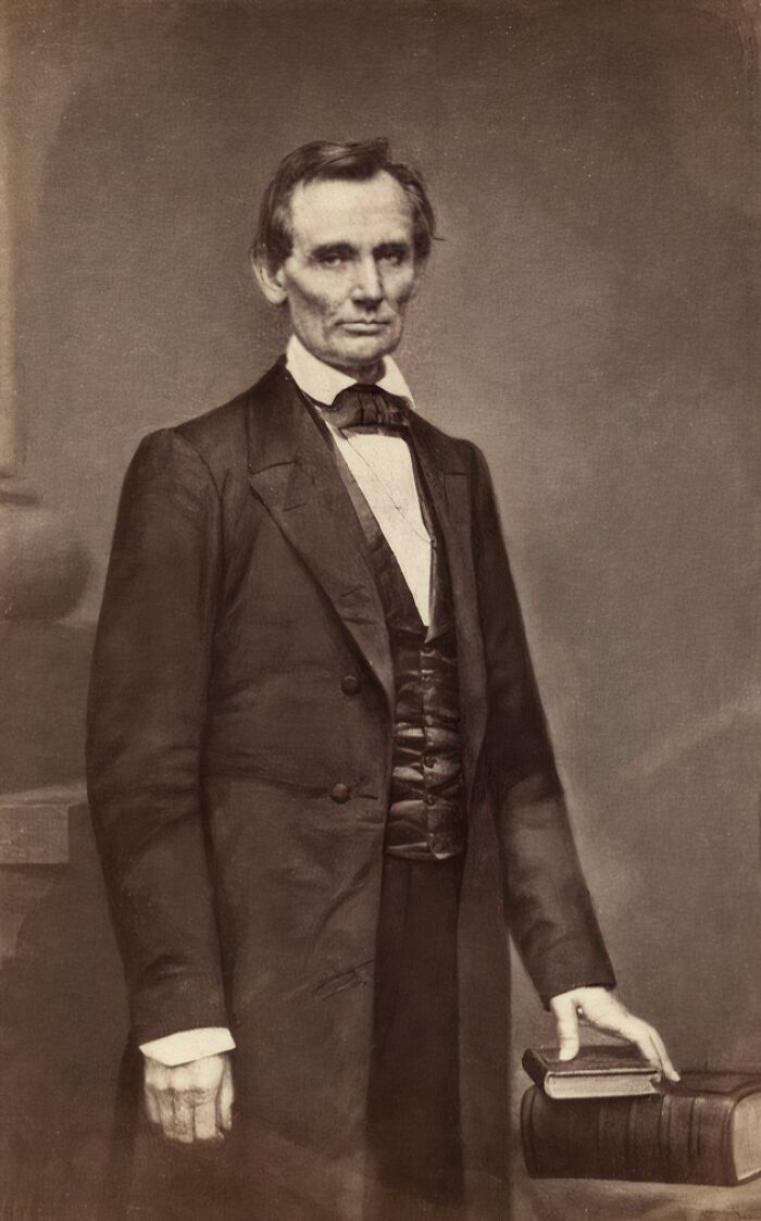 Portrait of a man in 1800s formal attire, standing beside books, depicting real story of 1800s America.