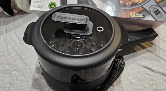 Black Ceramax electric cooker with glass lid and ergonomic handle, a dorm kitchen survival guide essential for easy meal prep.