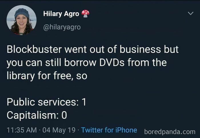 Tweet mocking statists highlighting public services over capitalism with a comparison of Blockbuster and library DVDs.