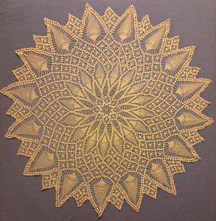 Intricate crocheted lace doily with floral and geometric patterns showcasing advanced crocheting skills.