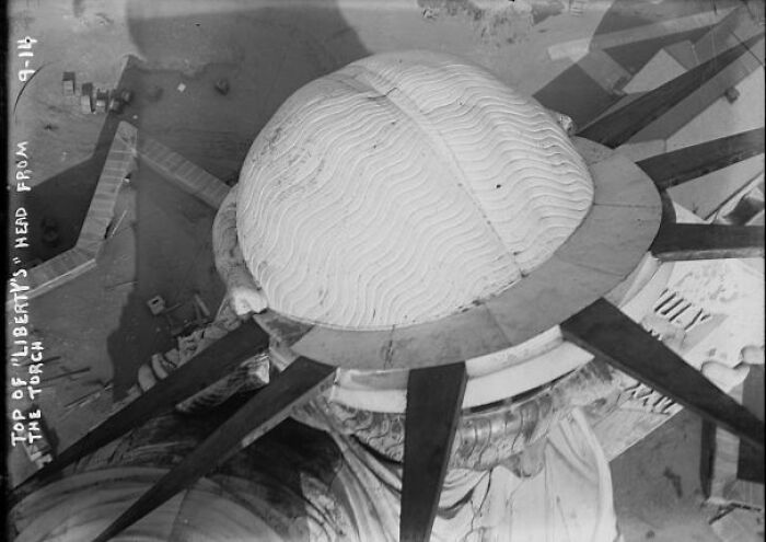 Aerial view of Statue of Liberty’s head and crown during construction, a fascinating historical photo.