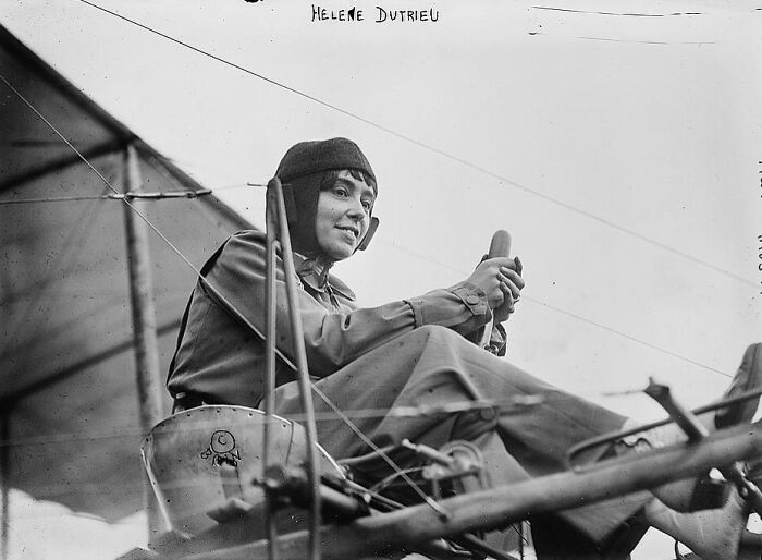 Vintage photo of a pilot in early aircraft cockpit, showcasing a weird and wonderful moment from historical photos.