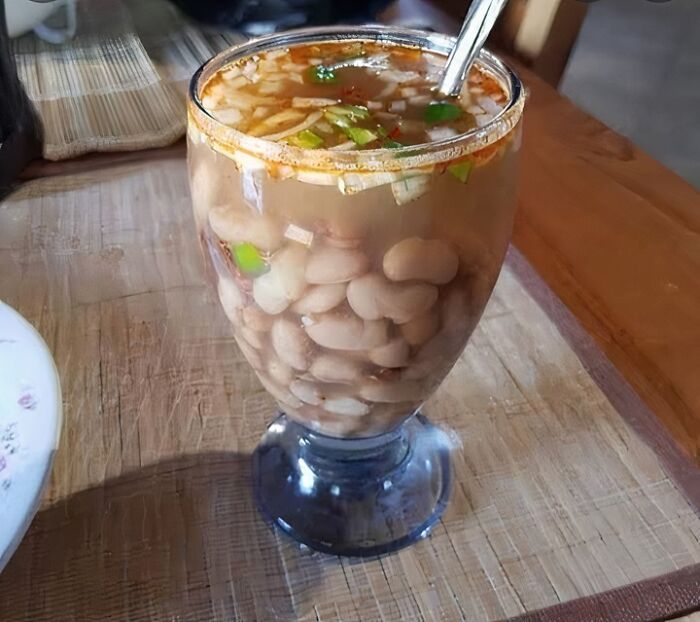 Glass filled with beans and broth with onions and spices, a food nobody should eat for physical and mental health risks