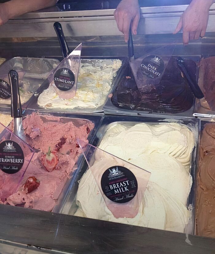 Various ice cream flavors including strawberry, breast milk, and dark chocolate in a display case, unhealthy food options.