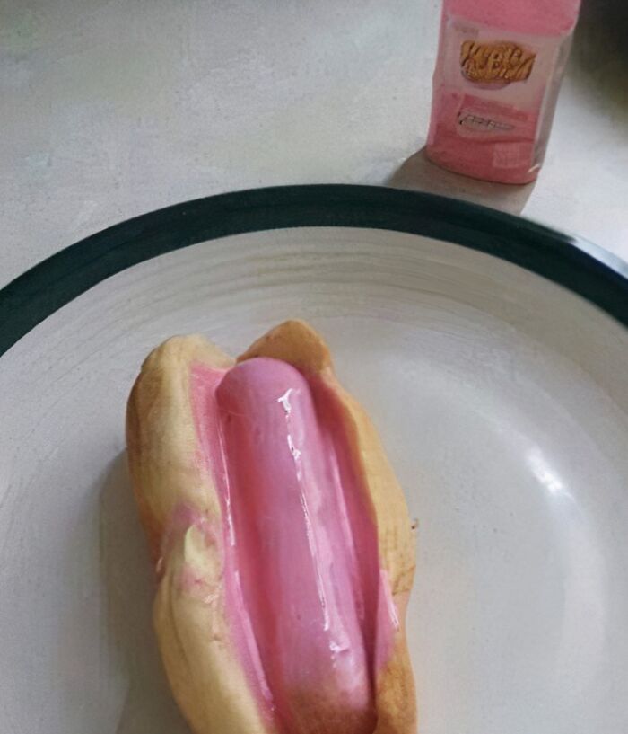 Pink hot dog inside a bun on a plate, illustrating food nobody should eat for physical and mental health.