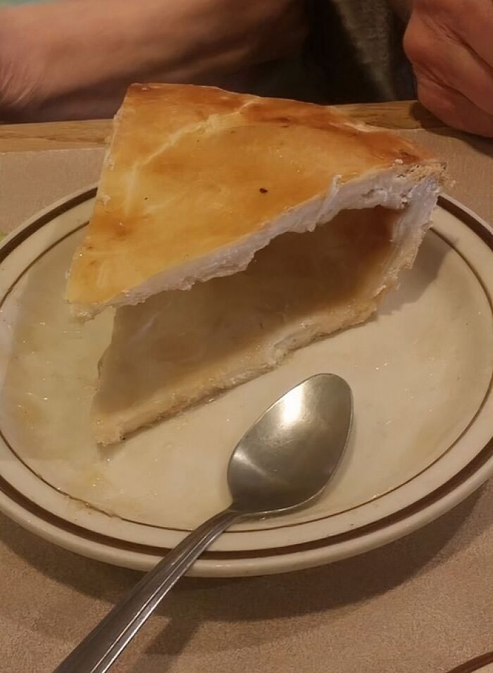 Slice of empty pie crust on plate with spoon, example of food nobody should eat for physical and mental health risks