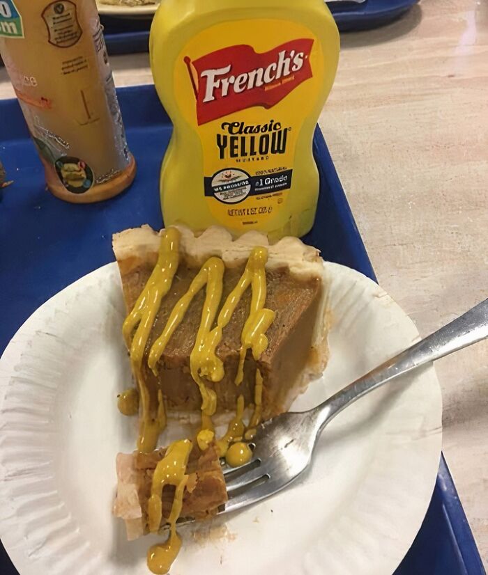 Slice of pie with mustard drizzled on top and a yellow mustard bottle, illustrating food nobody should eat for health.