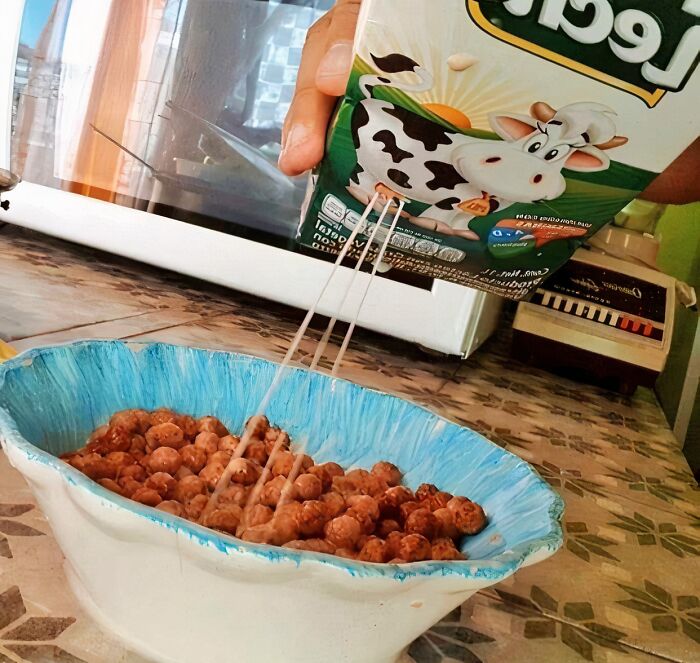 Chocolate cereal with milk being poured into a bowl, illustrating unhealthy food nobody should eat for mental health.