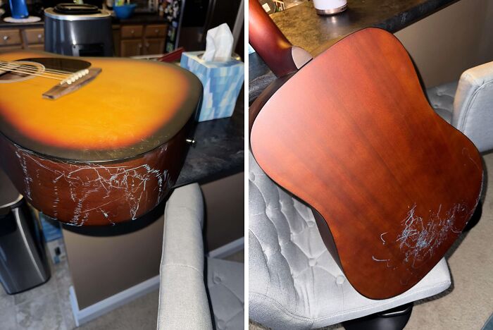 Acoustic guitar with deep scratches and damage showing carelessness and disregard for rules and etiquette around instruments.