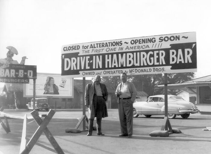 Vintage black and white photo of the first drive-in hamburger bar sign, a rare historical photo capturing early fast food history.