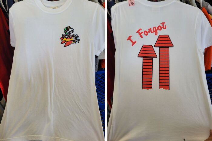 White thrift store t-shirt with a colorful cartoon design on front and red arrows with I Forgot text on the back.