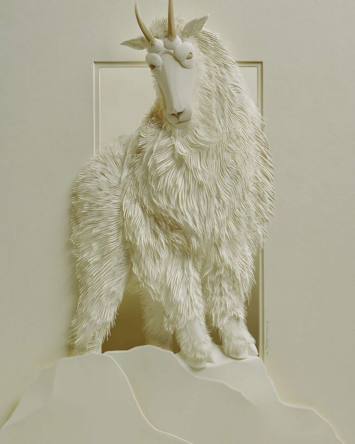 Realistic wildlife sculpture of a mountain goat made from intricately layered white paper by a talented artist.