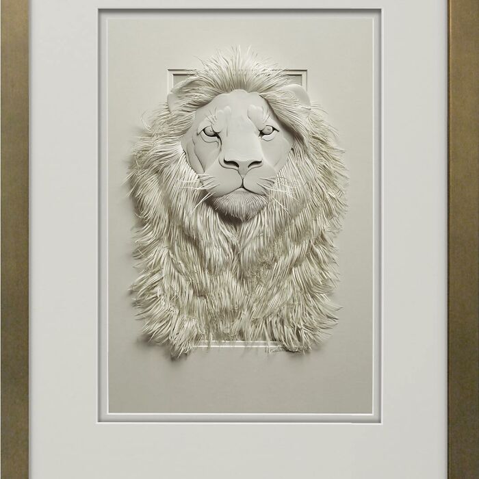 Paper wildlife sculpture of a lion with detailed mane and facial features showcasing realistic wildlife art craftsmanship.