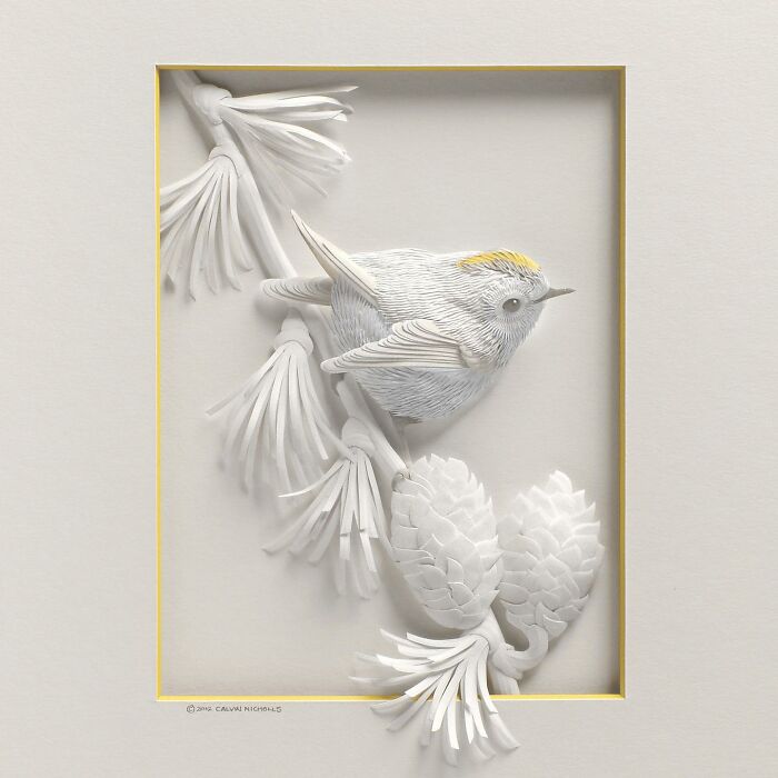 Paper wildlife sculpture of a bird perched on a branch with pine cones, showcasing stunningly realistic details.