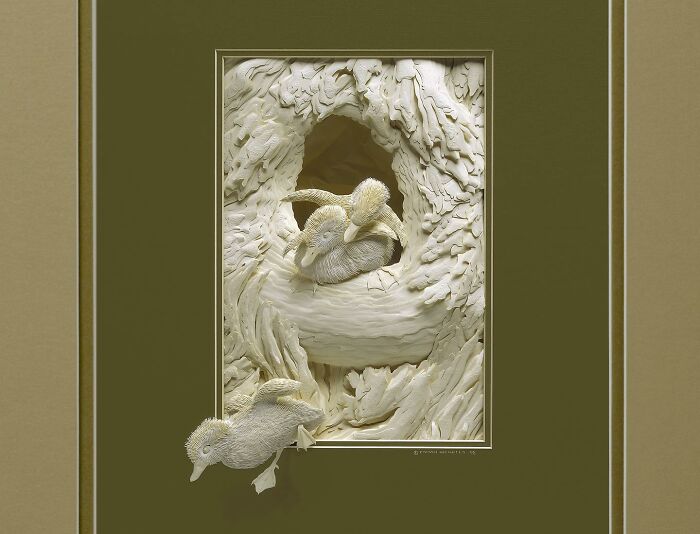 Paper artist creates stunningly realistic wildlife sculptures of ducks in a detailed natural setting with textured paper layers.