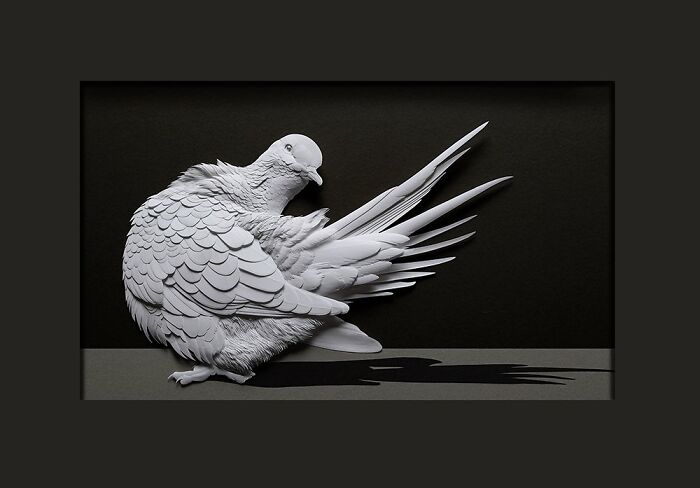 Realistic wildlife sculpture of a bird created from simple paper showcasing stunning detail and lifelike texture.
