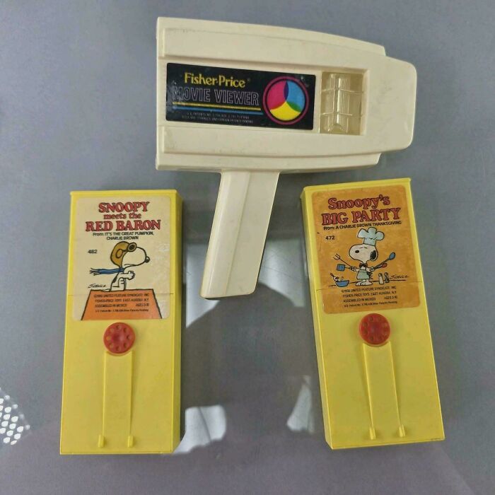 Vintage Fisher-Price movie viewer with Snoopy cartoon film reels, evoking nostalgia and memories of old age.