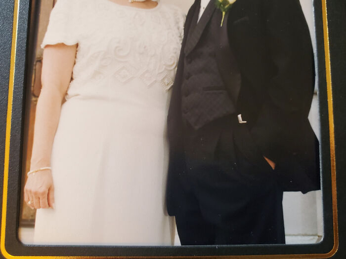 Close-up of a bride in a white dress and a groom in a black suit, highlighting wedding attire for brides and grooms.