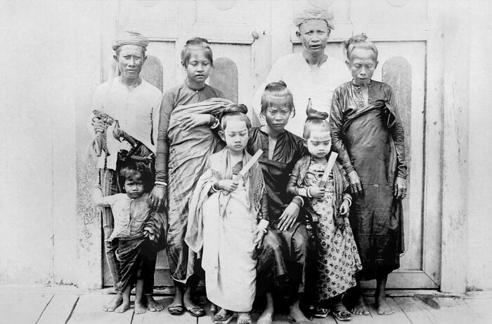Group portrait of Filipino people in traditional 1890s attire, showcasing cultural contrasts in the Philippines during the 1890s.
