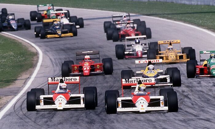 Formula 1 race cars speeding on track showcasing record-breaking inventions that move at mind-blowing speeds.