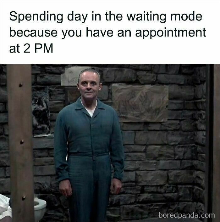 Man in a jumpsuit standing patiently in a dim stone room depicting relatable memes about waiting and appointment anxiety.