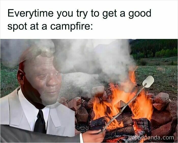 Man in suit with a sad expression tries to roast marshmallow, illustrating hilariously relatable memes about awkward campfire moments.