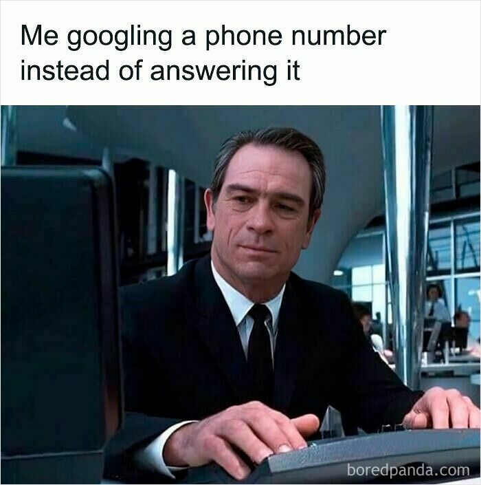 Man in suit at computer illustrating a hilariously relatable meme about googling a phone number instead of answering it