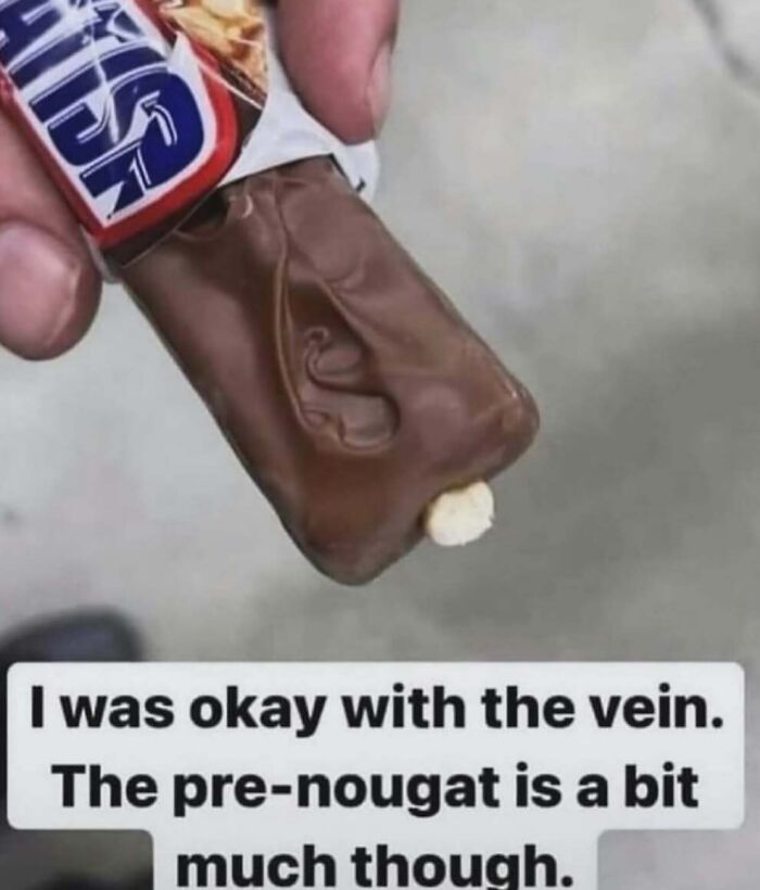 Hand holding a chocolate bar with a strange vein-like pattern, showcasing a daily cursed image from popular Instagram page.