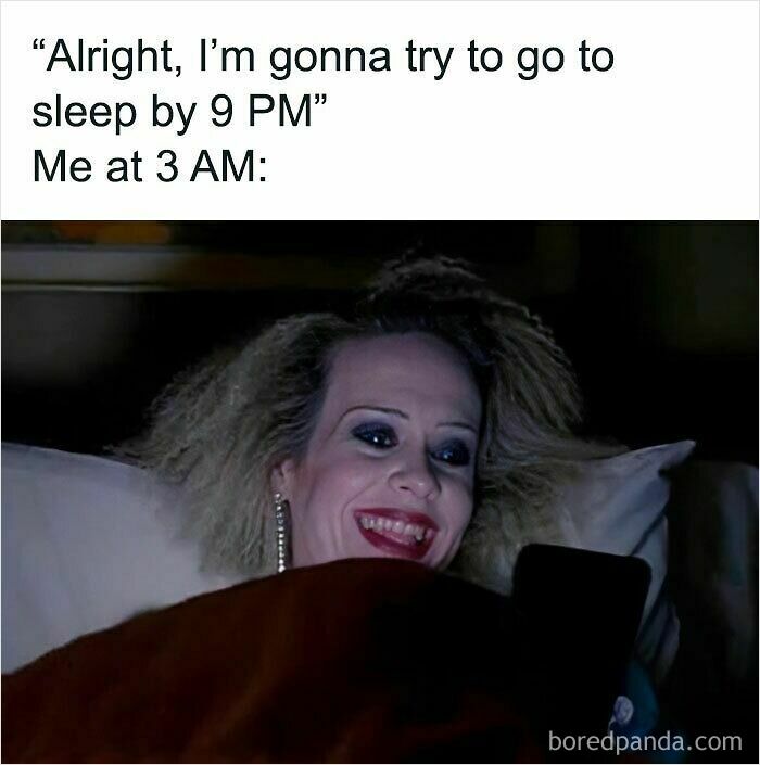Person with heavy makeup and messy hair smiling at their phone in bed, illustrating relatable memes about staying up late.