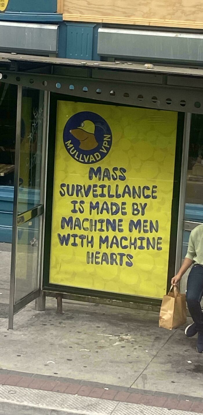 Bus stop ad with a message against mass surveillance, highlighting chaotic good people doing the right thing their own way.