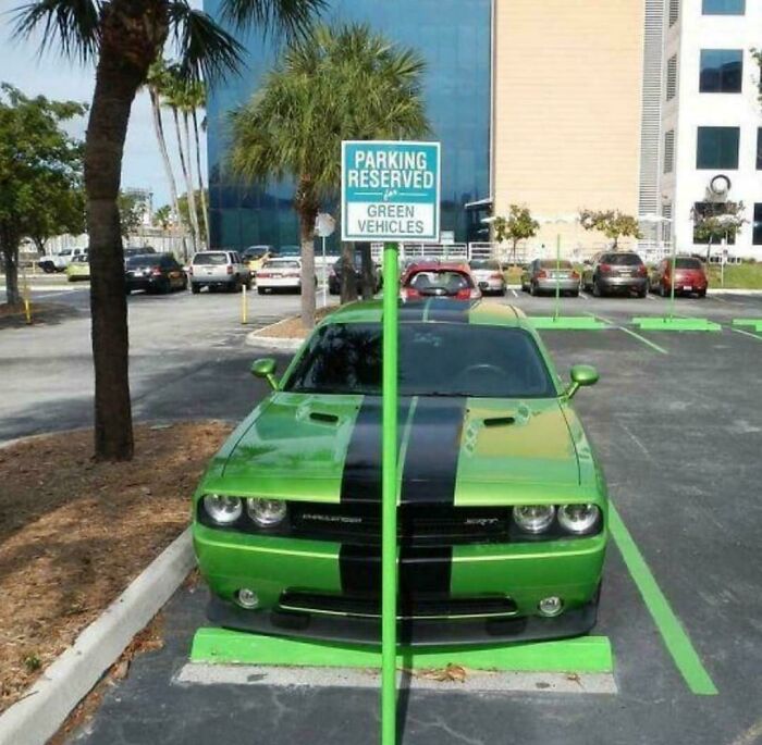 Green muscle car parked in a spot reserved for green vehicles, illustrating a typical parking fail shared online.