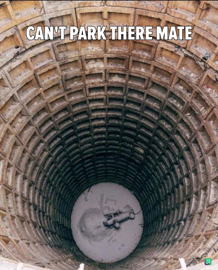 A toy car parked at the bottom of a deep well, illustrating a serious parking fail in an unusual spot.