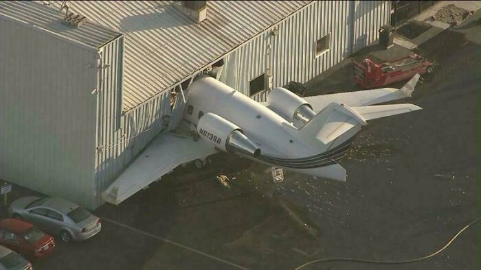 Small plane crashed into building wall next to parked cars, illustrating one of the most extreme parking fails caught on camera.