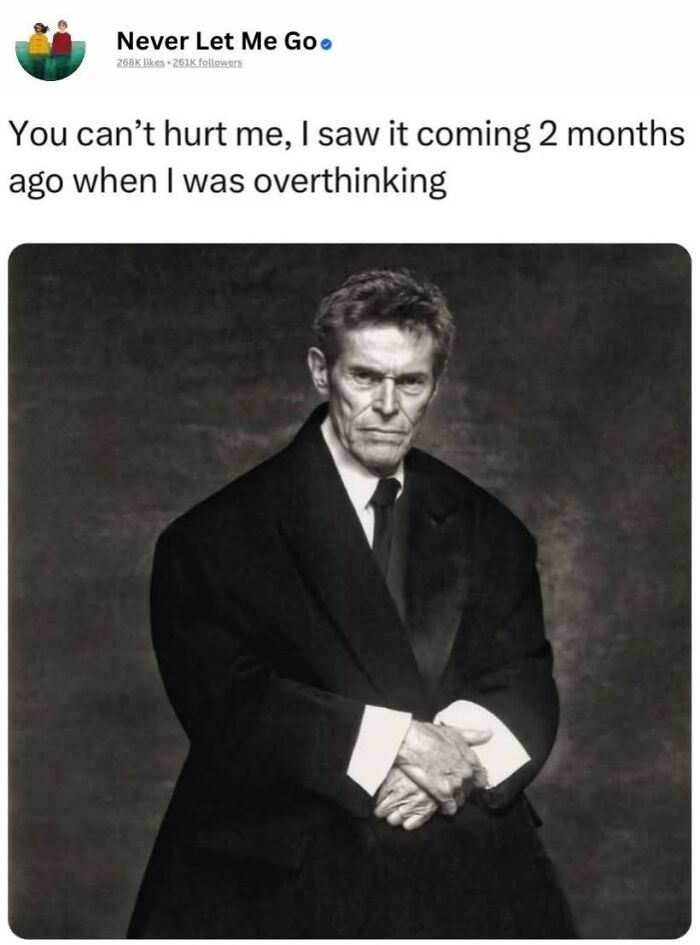 A black and white image of a serious man in an oversized suit illustrating a relatable meme for neurodivergent people about overthinking.