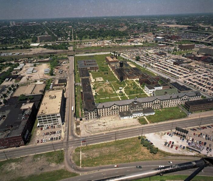 Aerial view of large abandoned places with dilapidated buildings and empty lots in an urban area.