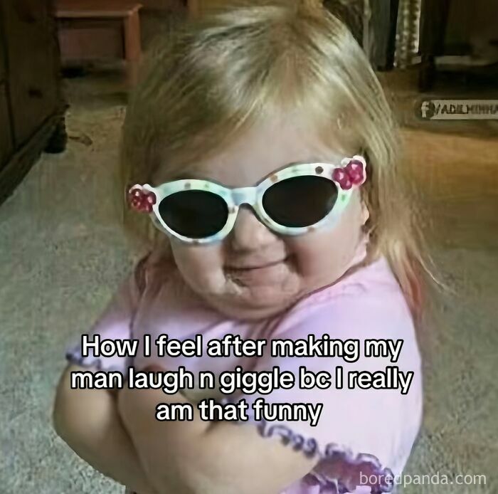Toddler wearing sunglasses with arms crossed, smiling confidently, expressing the cool mom attitude in parenting memes.