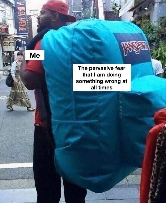 A person carrying a large backpack labeled with fear of doing something wrong, representing neurodivergent relatable memes.