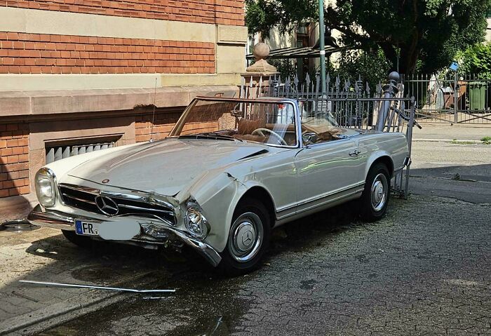 A vintage cream Mercedes convertible with significant front-end damage, part of a series of accidents and fails.
