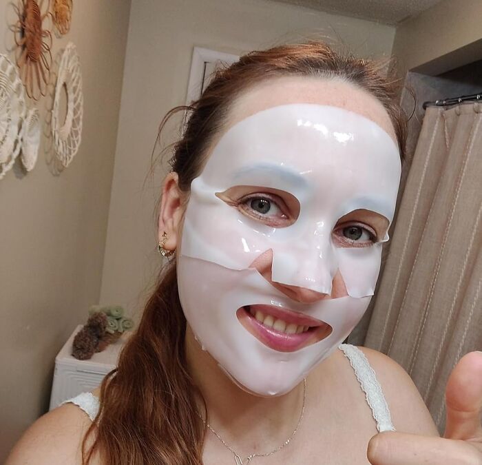 Woman wearing a hydrating face mask in a bathroom, showcasing one of Amazon's best seller list beauty products.