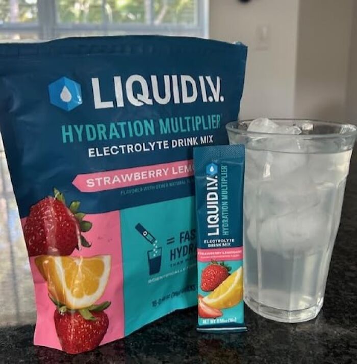 Hydration multiplier electrolyte drink mix and a glass of ice water on a kitchen counter, a top Amazon best seller product.