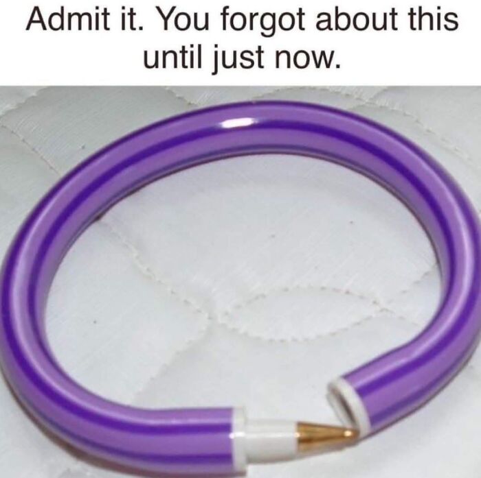 Purple bendable pencil forming a loop on a white quilted surface, evoking 90s nostalgia and childhood memories.