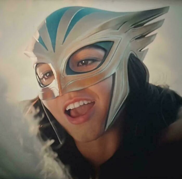 Close-up of a person wearing a detailed silver and blue superhero helmet, featured in discussions of bad movie details.