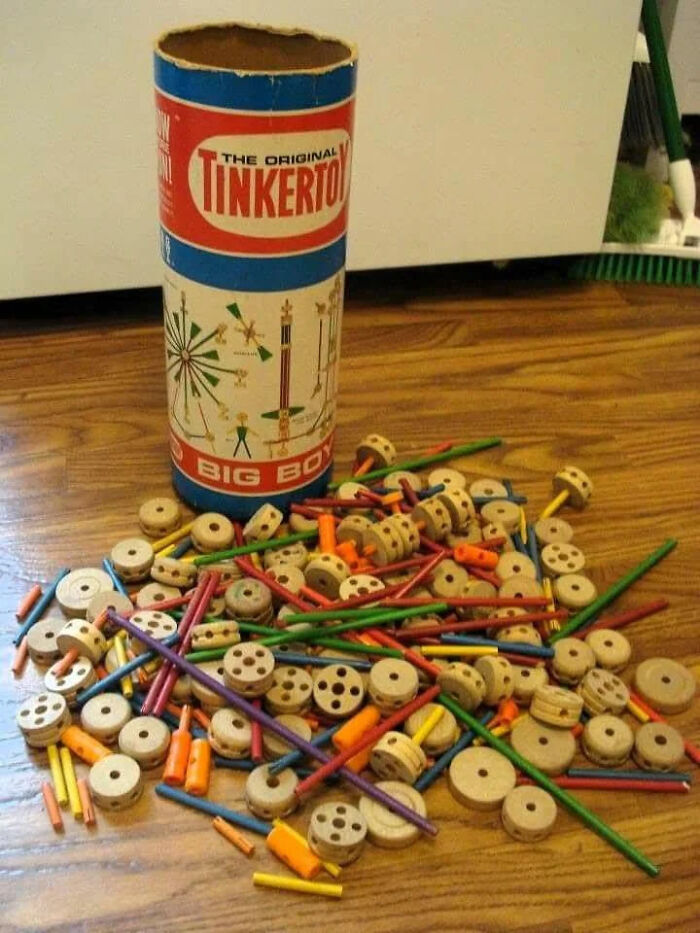 Vintage Tinkertoy construction set with wooden spools and colorful sticks evoking nostalgia and old age memories