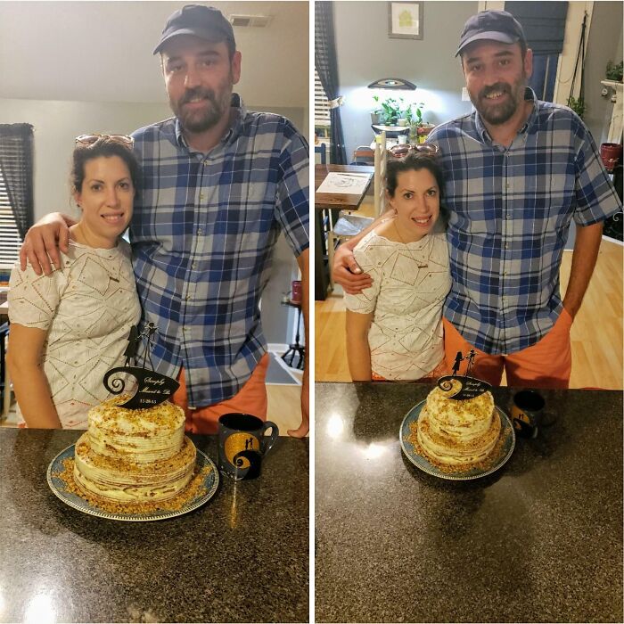 Couple posing with a tiered cake and coffee mug on kitchen counter, showing casual celebration in home setting.