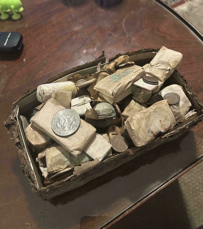 Box filled with old wrapped coins and loose change, a moderately interesting find shared by people around the world