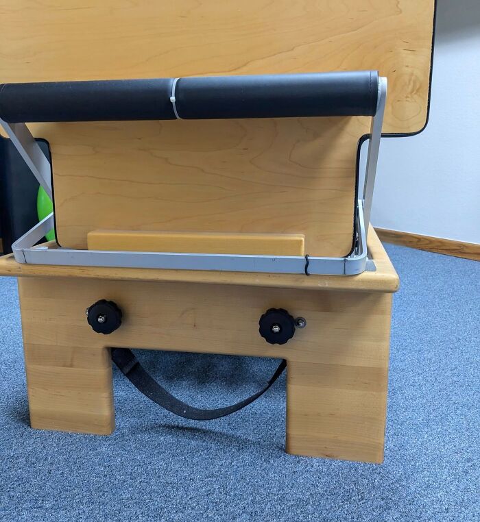 Wooden object with bolts and strap resembling a face, illustrating random objects that look like faces.