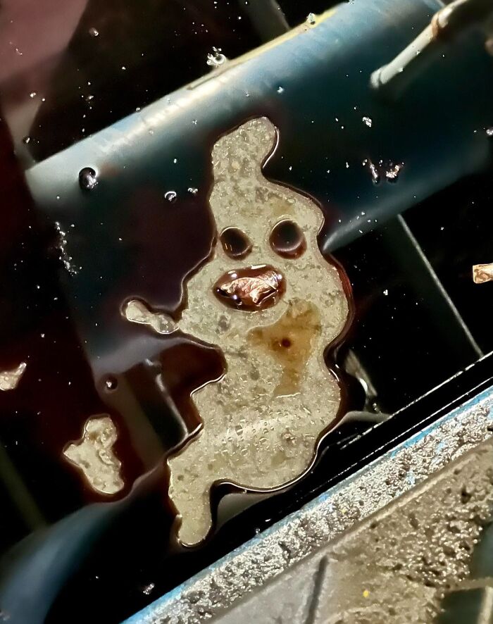 Random object in liquid resembling a face with eyes and mouth, shared in a group posting random objects that look like faces.