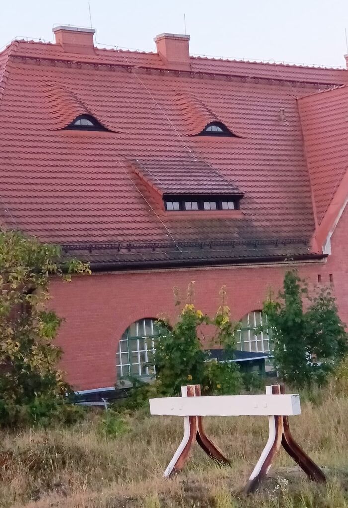 Roof windows arranged to resemble a face with eyes and mouth, an example of random objects that look like faces.